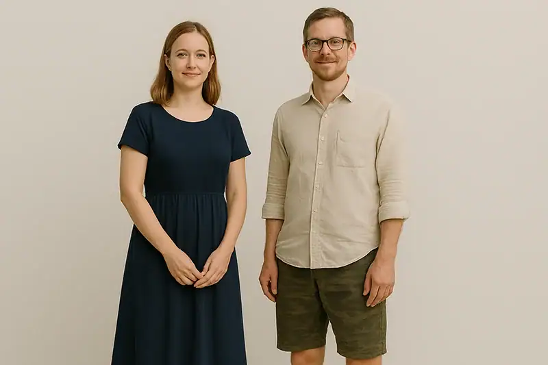 Tourist couple wearing proper dress for Batu Caves — the woman in a knee-length dress and the man in a collared shirt with knee-length shorts, both suitable for visiting the site.