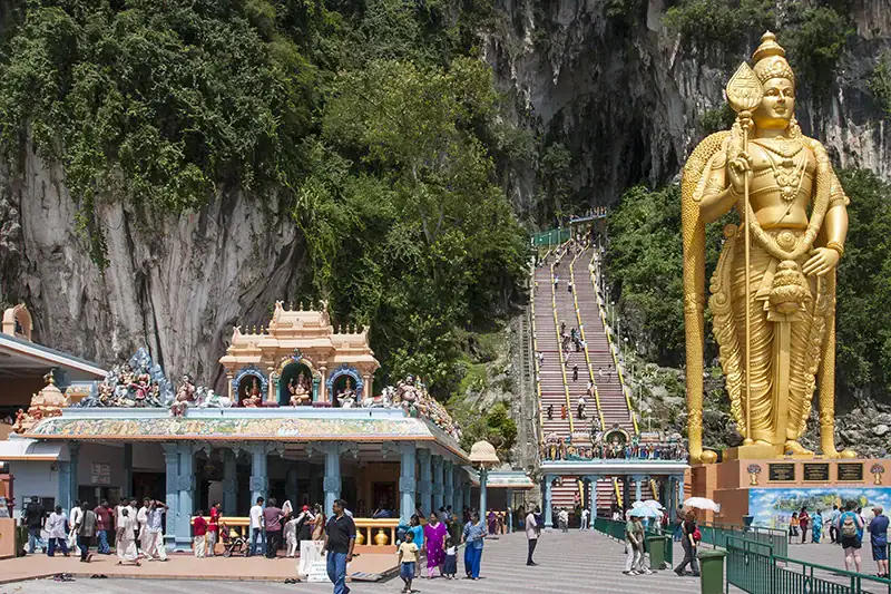 Historic 2006 photo of Batu Caves showing the old three-lane staircase and golden Lord Murugan statue before the rainbow-colored renovation