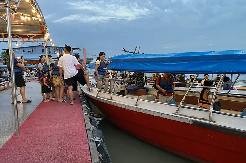 Tourists boarding a fireflies boat ride at Pasir Penambang Jetty in Kuala Selangor, Malaysia