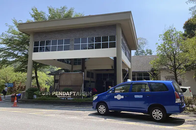 Taxi dropping off visitors at Kuala Gandah Elephant Sanctuary registration lobby