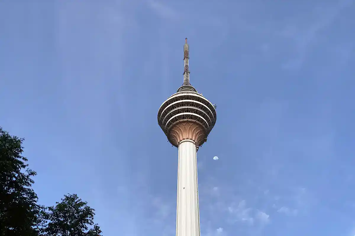 KL Tower standing against a clear blue sky, one of the best spots for panoramic city views in Kuala Lumpur.