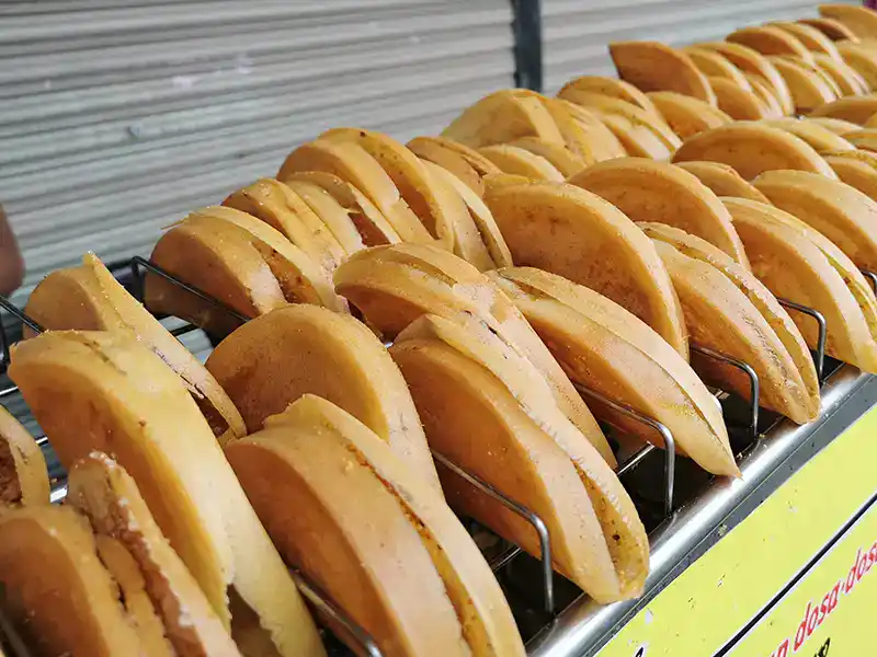Apam balik street food in Kuala Lumpur Malaysia, freshly cooked Malaysian pancake snack popular at night markets and a must-try local treat for tourists.