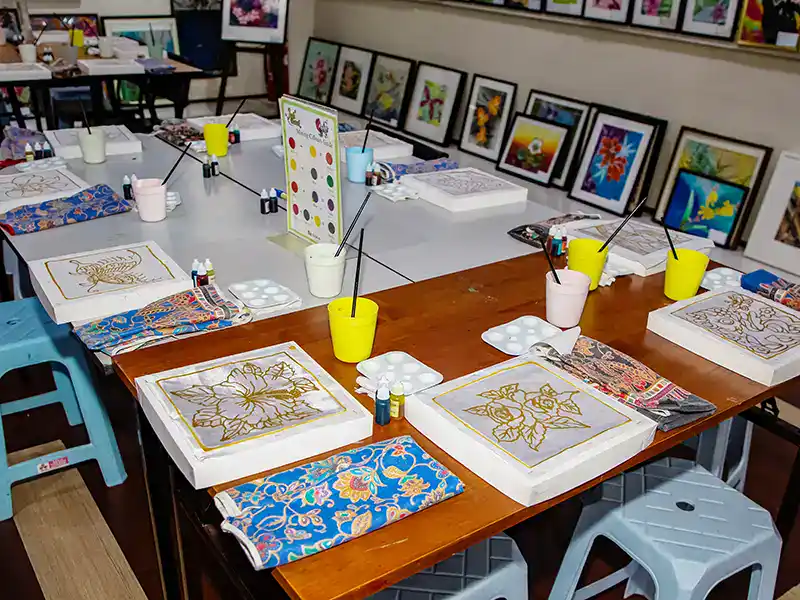 Batik drawing workshop in Kuala Lumpur where tourists paint traditional Malaysian designs