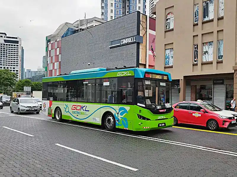 GO KL city bus in Kuala Lumpur passing through the downtown area, a budget-friendly way for tourists to get around the city.