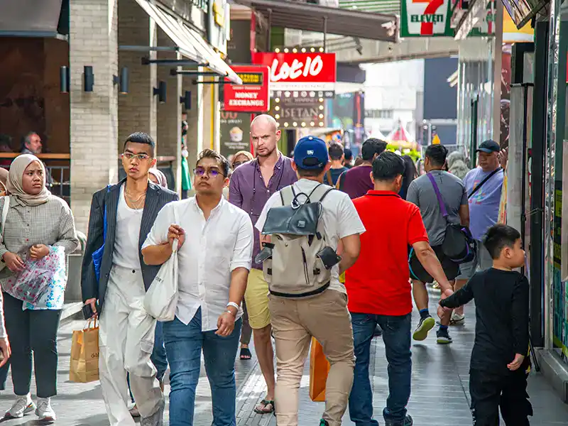 Tourists walking along a busy pedestrian street in Bukit Bintang Kuala Lumpur, one of the most popular areas to explore on foot
