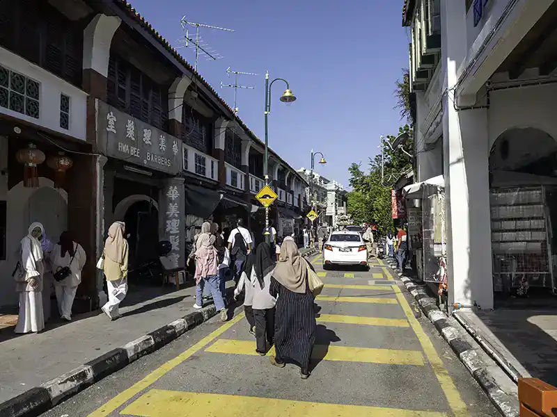 Pedestrian street scene on Armenian Street in George Town Penang with heritage shophouses