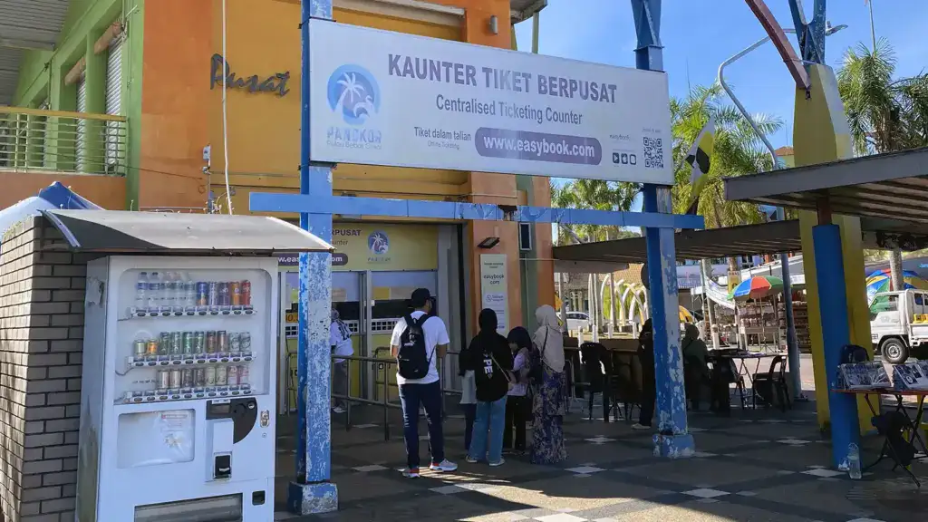 Passengers queuing at the ferry ticket counter at Lumut Jetty