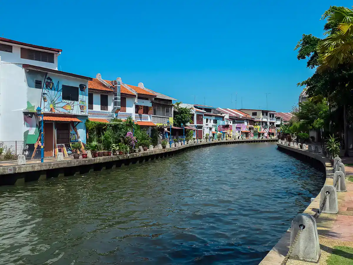 The Malacca River flowing through the historic old town with heritage buildings along the riverbank