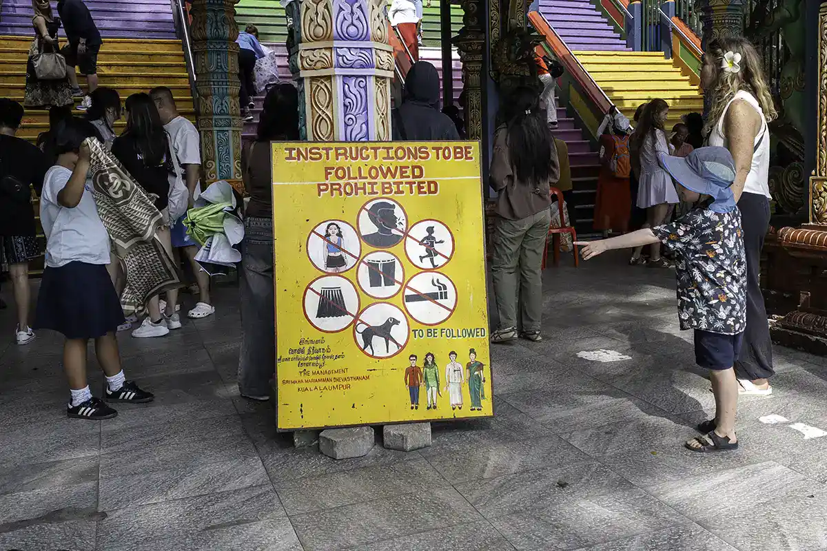 Dress code and behaviour guidelines displayed at the entrance of Batu Caves